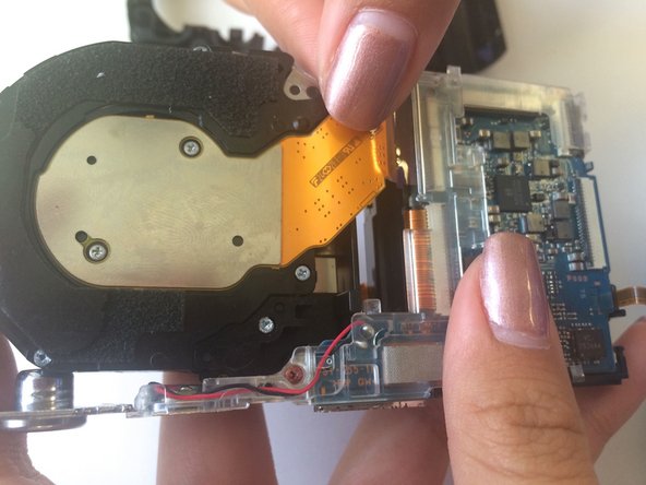 Cyber-shot DSC-H55 Lens Replacement, Removing Ribbon Wires around Lens: crwdns2935265:011crwdnd2935265:02crwdnd2935265:03crwdne2935265:0