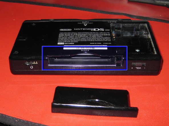 Remove the plastic insert (or cartridge) from the lower slot (Slot 2).