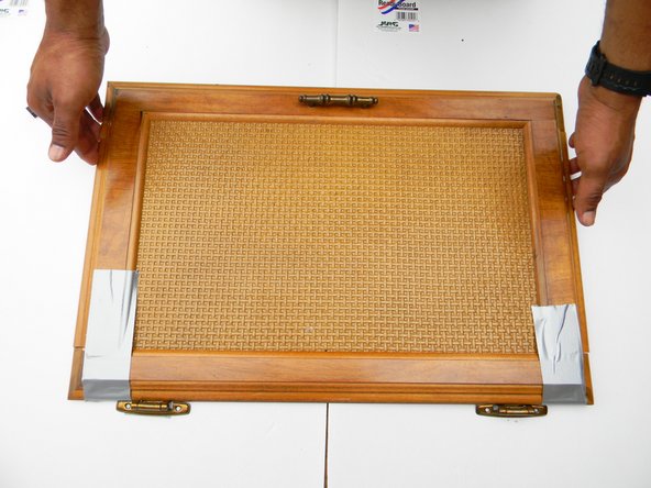 Flip door over to front side and tape both ends of the cabinet. This will add more support while it is drying.