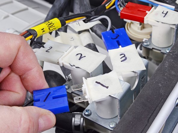 LG WM3050CW Inlet Valve Assembly Replacement, Disconnect the inlet valve: crwdns2935265:06crwdnd2935265:02crwdnd2935265:03crwdne2935265:0