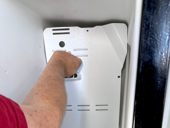 Frigidaire Side-By-Side Refrigerator Evaporator Fan Cover Removal, Remove the upper evaporator cover: crwdns2935265:014crwdnd2935265:02crwdnd2935265:03crwdne2935265:0