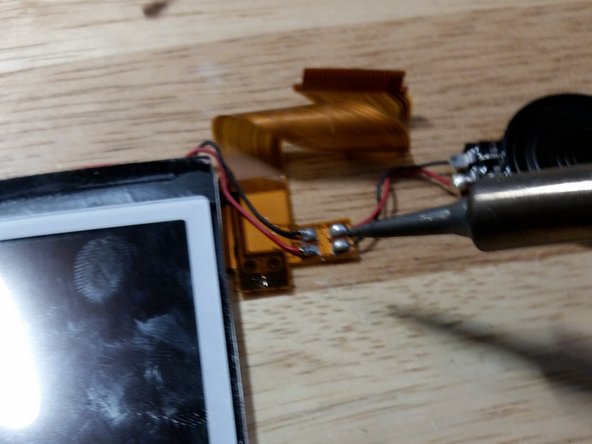 This step is only necessary if your upper LCD is bad. Unfortunately, this is a common problem. First, wet the contacts with flux. Then, with your iron at 400 degrees C, melt the solder and remove all four wires. It might help to add fresh solder with lead. The lead-free solder used by Nintendo sucks.
