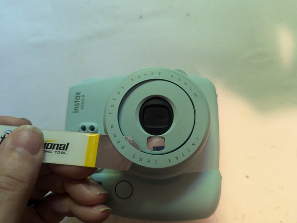 Fujifilm Instax Mini 9 Camera Shell Replacement, Remove the Brightness Adjustment Dial Cover: crwdns2935265:07crwdnd2935265:03crwdnd2935265:03crwdne2935265:0