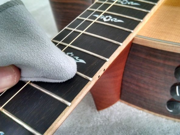 How to clean and maintain your Taylor 816CE, Clean second half of fretboard, body, and headstock: crwdns2935265:05crwdnd2935265:02crwdnd2935265:02crwdne2935265:0