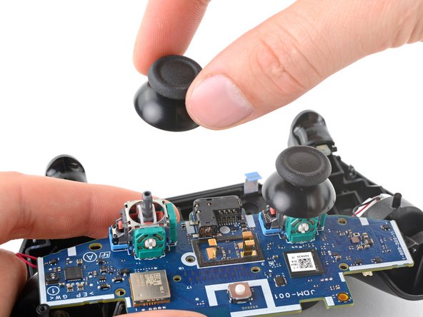 DualShock 4 (CUH-ZCT1U) Analog Stick Covers Replacement, Remove the analog stick covers: crwdns2935265:021crwdnd2935265:02crwdnd2935265:03crwdne2935265:0