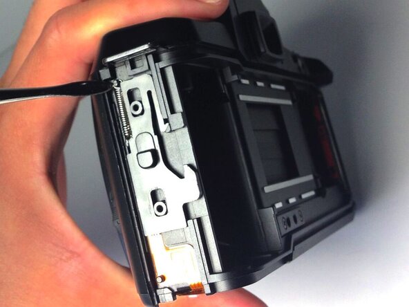 Pentax PZ-10 Back Cover Locking Switch Spring Replacement, Removing the Spring: crwdns2935265:07crwdnd2935265:01crwdnd2935265:01crwdne2935265:0