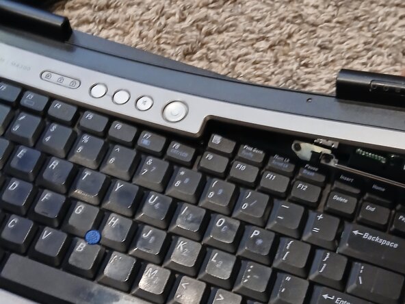 Dell Precision M4300 Keyboard Replacement, Remove button trim.: step 1, image 2 of 2