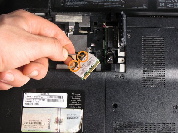 Remove the WLAN module by pulling it away from the slot at an angle.