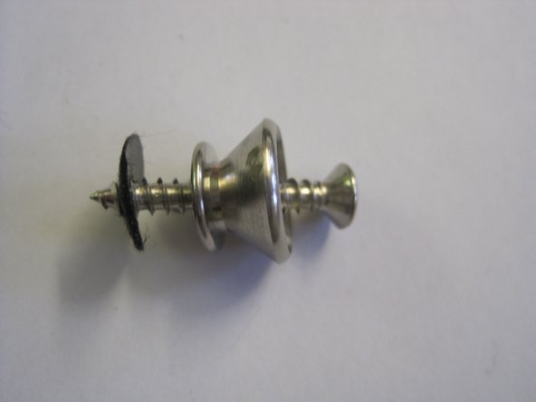 Unscrew the screw holding the bottom strap button in position.