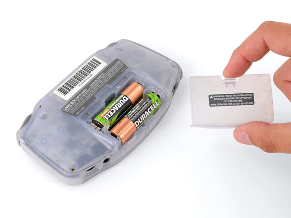 How to Reshell Your Game Boy Advance, Remove the battery cover: crwdns2935265:02crwdnd2935265:03crwdnd2935265:03crwdne2935265:0