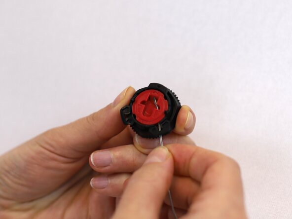 How to Replace a Dial-Lace System in a Hiking Boot, Insert the metal loop: crwdns2935265:012crwdnd2935265:02crwdnd2935265:03crwdne2935265:0