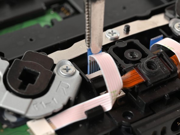 DualSense Edge Rear Microphone Replacement, Remove the back button ribbon cable: crwdns2935265:019crwdnd2935265:02crwdnd2935265:02crwdne2935265:0