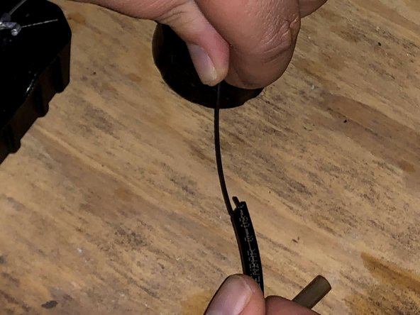 Insert the hooked end of the gripping tool into the fuel line.