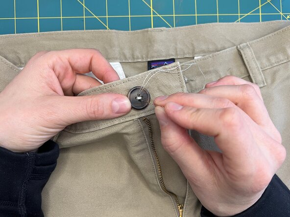 Sew a Button onto Heavy Fabric, Continue stitching the button: crwdns2935265:07crwdnd2935265:02crwdnd2935265:03crwdne2935265:0