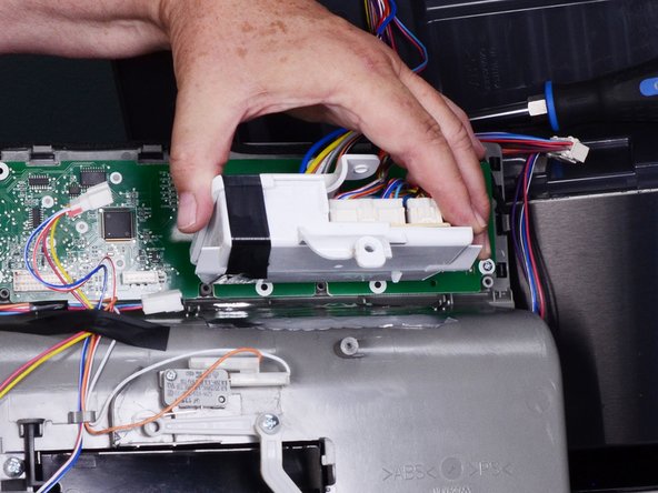 LG Refrigerator Water Dispensing Switch Testing and Replacement, Unfasten the circuit board holder: crwdns2935265:010crwdnd2935265:03crwdnd2935265:03crwdne2935265:0