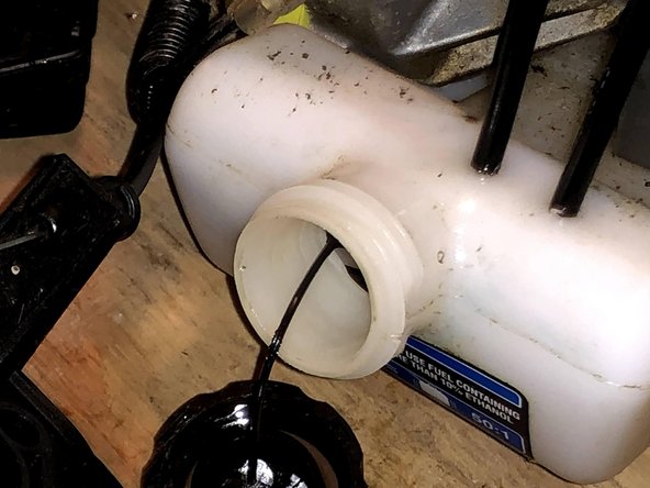 Push the remaining fuel line into the gas tank.