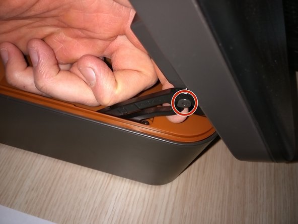 After removing the seven screws, loosen the lever from the scanner compartment.