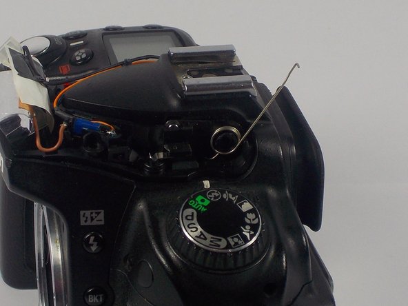 Nikon D90 Flash Hinge Spring Replacement, Releasing the Spring: crwdns2935265:05crwdnd2935265:02crwdnd2935265:02crwdne2935265:0