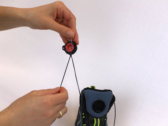 How to Replace a Dial-Lace System in a Hiking Boot, Insert the lace into the dial: crwdns2935265:013crwdnd2935265:03crwdnd2935265:03crwdne2935265:0
