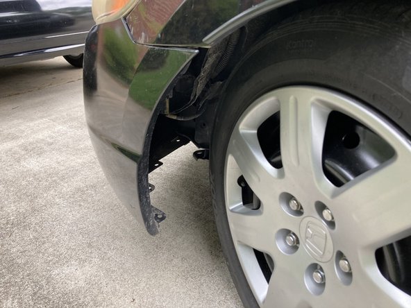 Sit next to your tire and look under the body toward the front of the car.