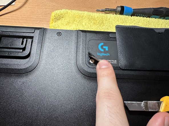 Logitech G915 Wireless: Key switch repair/replacement, Removing Screws Under Label: crwdns2935265:04crwdnd2935265:02crwdnd2935265:02crwdne2935265:0