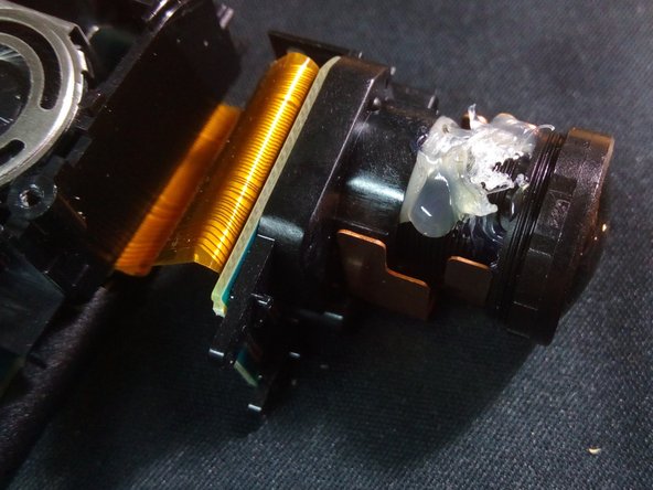 Desmontagem da câmera de vídeo Sony MV1, Aplicar cola quente na lente Sony MV1: crwdns2935265:08crwdnd2935265:02crwdnd2935265:02crwdne2935265:0