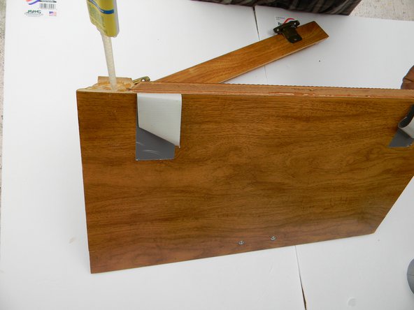 Run a thick bead of epoxy on the inside rim of the cabinet from one end to the other.