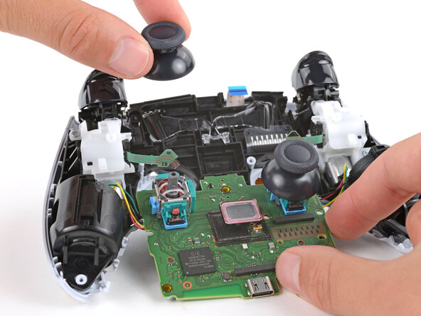 DualSense Controller V5 Joystick Covers Replacement, Remove the joystick covers: crwdns2935265:026crwdnd2935265:02crwdnd2935265:03crwdne2935265:0