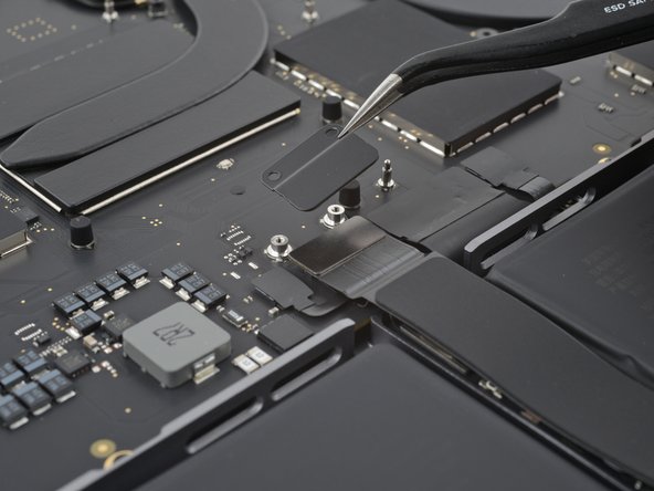 MacBook Pro 14" Late 2023 (M3) USB-C Ports Replacement, Remove the trackpad connector cover: crwdns2935265:08crwdnd2935265:02crwdnd2935265:02crwdne2935265:0