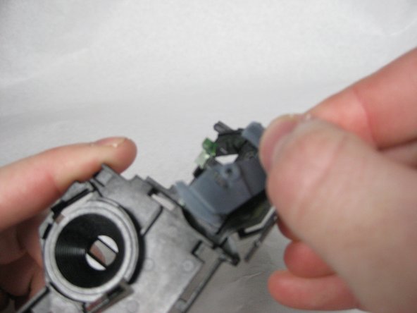 Lift the light blue piece out of the mechanism.