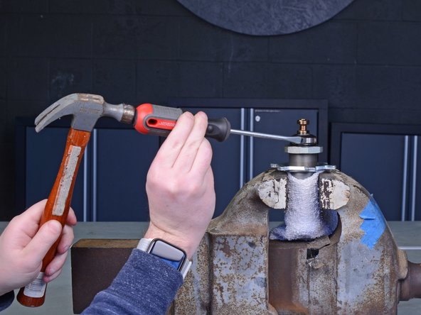 Use a flathead screwdriver and mallet to unscrew and loosen the top jam nut.