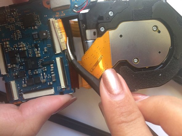 Cyber-shot DSC-H55 Lens Replacement, Removing Ribbon Wires around Lens: crwdns2935265:011crwdnd2935265:03crwdnd2935265:03crwdne2935265:0