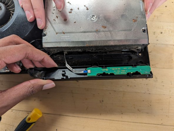 PlayStation 3 Slim Thermal Paste Replacement, Removing the power button board: crwdns2935265:013crwdnd2935265:03crwdnd2935265:03crwdne2935265:0