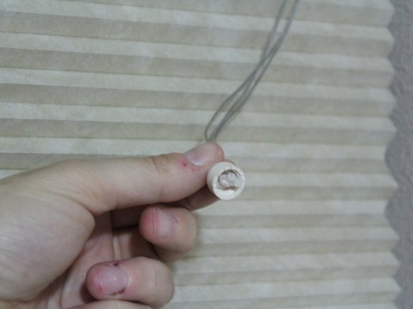 Screw the lower half of the tassel onto the top half.