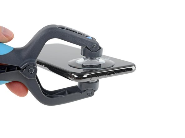 Hold onto your iPhone securely and close the handle of the iSclack to slightly separate the screen from the rear case of the phone.