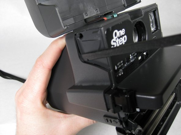 Insert spudger in between face of camera and sides where the four tabs are located.