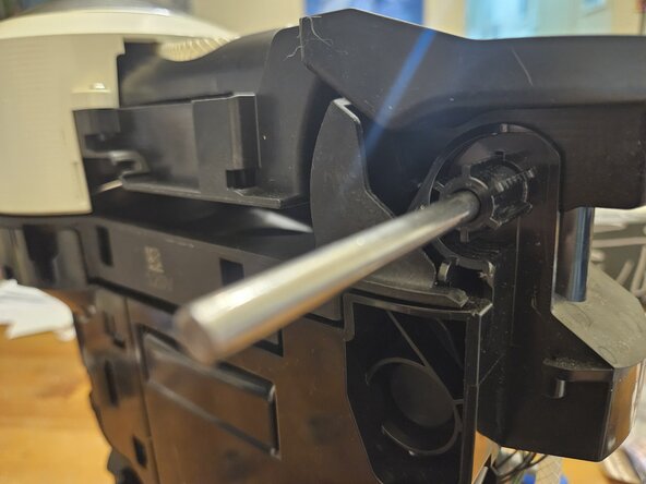 Nespresso Vertuo Next Pod holder , barcode reader and drain pipe Replacement, Remove the Springs and pivot rod: step 6, image 3 of 3