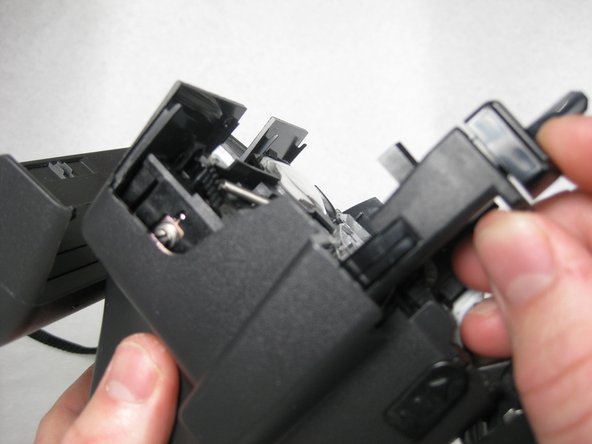 There are two pieces to the capture button and both should be removed.