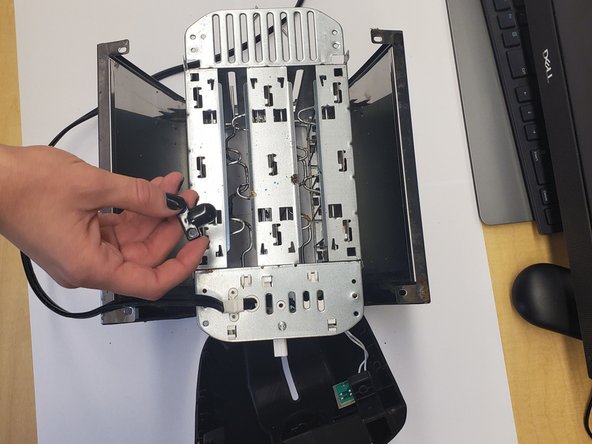 Toaster Teardown, Remove the 2 screws from power cord immobilizer: crwdns2935265:05crwdnd2935265:01crwdnd2935265:02crwdne2935265:0