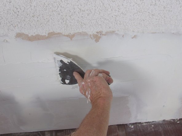 If the mesh does show through, pat the  sanded area with a lightly dampened sponge, reapply a thin layer of joint compound, let dry and sand again before proceeding.