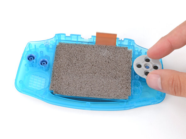 How to Reshell Your Game Boy Advance, Install the silicone pads: crwdns2935265:025crwdnd2935265:01crwdnd2935265:03crwdne2935265:0
