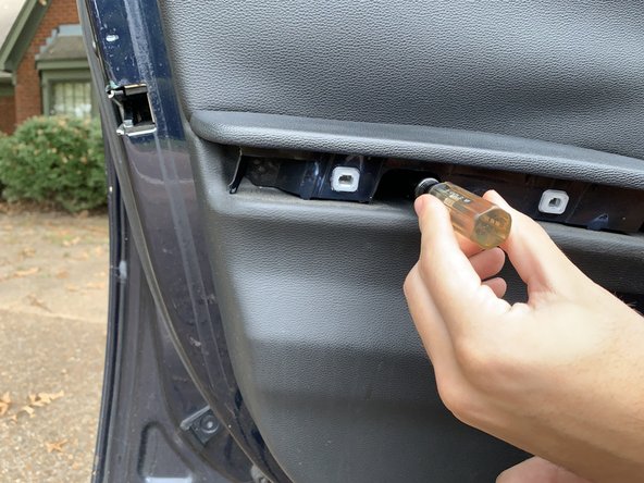 Using a T20 Torx, remove the three screws located behind the previously removed trim.