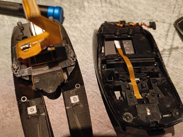 Logitech MX Air Battery Replacement, Separate the button layer, and remove the battery.: crwdns2935265:06crwdnd2935265:01crwdnd2935265:02crwdne2935265:0