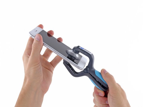 Hold onto your iPhone securely and close the handle of the iSclack to separate the suction cups, pulling the front panel up from the rear case.