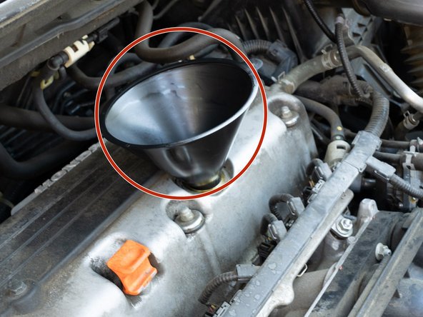 Place the medium funnel and  add new 0W-20 full synthetic engine oil.  Add  4.2 quarts of oil.