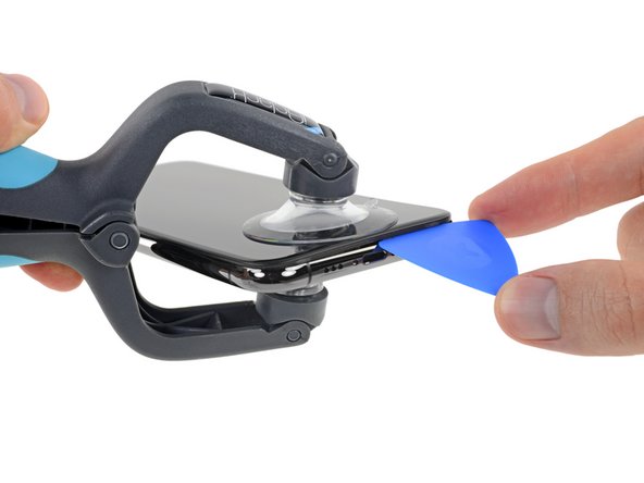 Insert an opening pick into the gap under the display on the lower edge of the iPhone.
