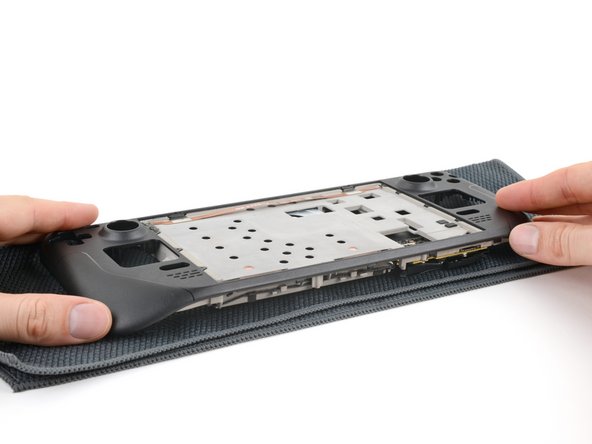 Steam Deck OLED Front Shell Replacement, Flip over the Steam Deck OLED: crwdns2935265:085crwdnd2935265:03crwdnd2935265:03crwdne2935265:0