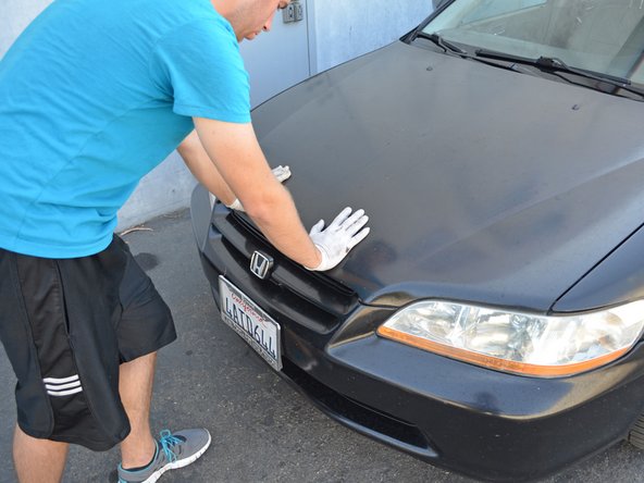 Push down firmly on the hood to secure it in place.