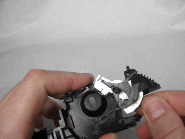 Remove the Shutter mechanism from the back of the lens plate.