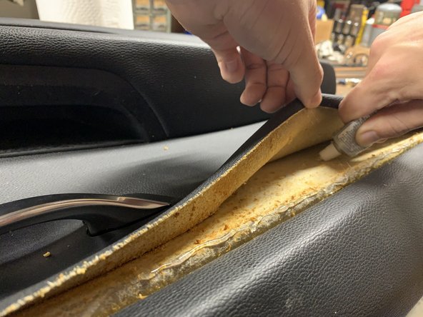 Apply a line of glue along the top edge and under the middle of the leather liner.